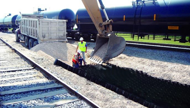 Image of ballast being applied to geocell in railway application - Presto Geosystems