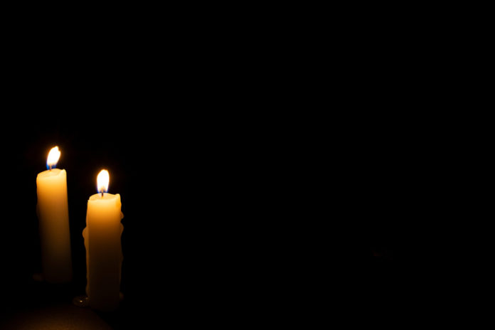 Two candles in the darkness image, in mermoriam