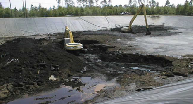 Photo of dredging equipment within the sludge lagoon at a wastewater treatment facility