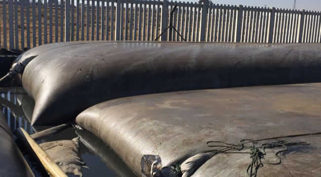 Main photo of the geotextile dewatering bags. Here, they are visually taut, as sludge has been pumped into them.