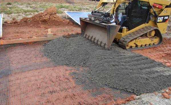 Photo of geosynthetics being installed and covered with aggregate in test section